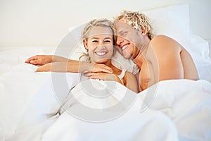 Happy young couple in bed