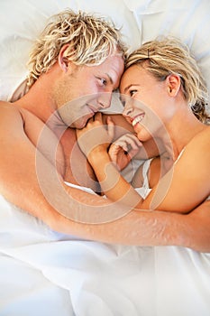 Happy young couple in bed