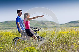 Happy young couple on a bike ride in the countryside