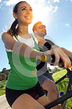 Happy young couple on a bike ride in the countryside