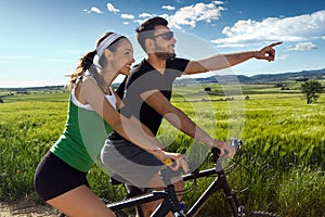 Happy young couple on a bike ride in the countryside