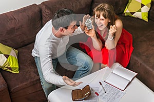 Happy young couple calculating family budget