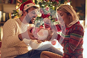 Happy young couple celebrating Christmas and having fun