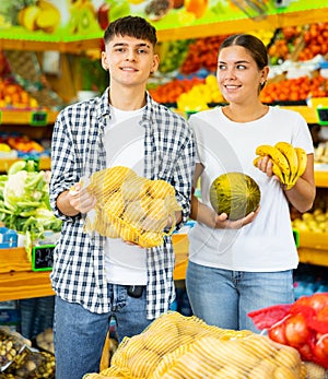 Happy young couple chooses products