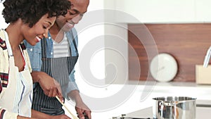 Happy young couple cooking together