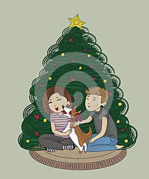 happy young couple with a corgi dog with a red bow around his neck sitting together near the christmas tree at home on a cozy