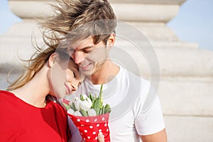 Happy young couple cuddle outdoor