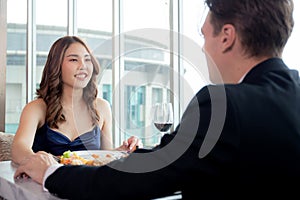 Happy young couple date with romance together in anniversary at restaurant luxury for celebrate.