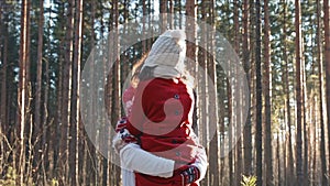Happy young couple dating in winter forest. Xmas holidays concept. Family weekend spend time together. Christmas eve and