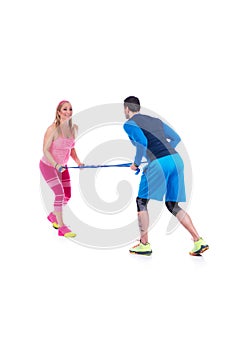 Happy young couple doing exercise in pair with elastic rubber for pregnancy on the white background