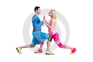 Happy young couple doing exercise in pair for pregnancy on the white background