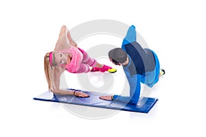 Happy young couple doing exercise in pair for pregnancy on the white background