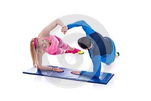 Happy young couple doing exercise in pair for pregnancy on the white background