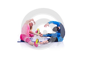 Happy young couple doing exercise in pair for pregnancy on the white background