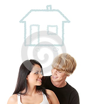 Happy young couple dreaming about their new home