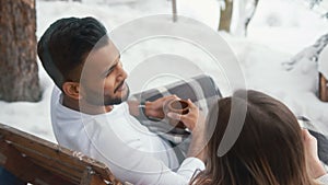 Happy young couple drinking hot chocolate on the balcony on winter day. Christmas or valentines day. Overhead shot