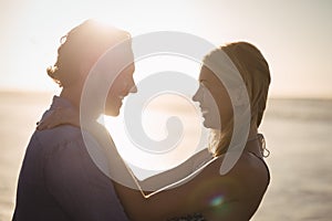 Happy young couple embracing at beach