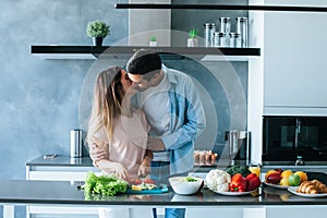 Happy young couple embracing during breakfast