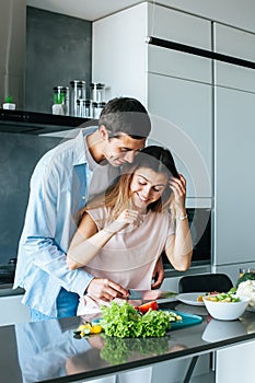 Happy young couple embracing during breakfast