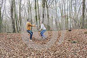 Happy young couple enjoy playing and laughing in amazing forest.Romantic , love lifestyle.Travel with friends and friendship