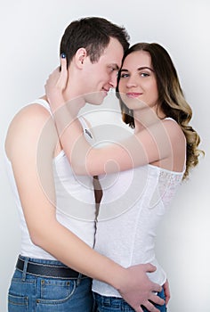 Happy young couple enjoying an intimate moment, laughing a lot and man gently strokes his partner's hair