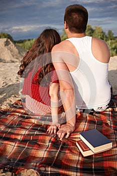 Happy young couple enjoying picnic and have good time on summer