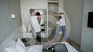 Happy young couple excited about their vacation. Man in white T shirt throwing currency notes in air on his wife