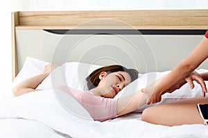 Happy young couple friend beautiful asia women having a pillow fight in their bedroom
