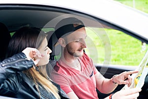 Happy young couple, friends making selfie while sitting in car. Summer time. Caucasian people. Concept of transportation.