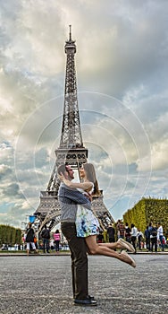 Happy Young Couple in Front of the Eiffel Tower