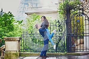 Happy young couple in front of the Eiffel tower