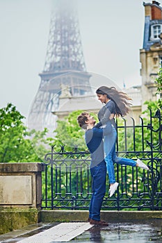 Happy young couple in front of the Eiffel tower