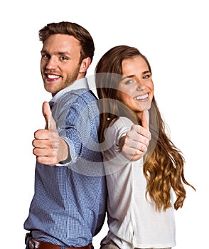 Happy young couple gesturing thumbs up