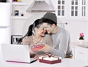 Happy young couple with gift boxes