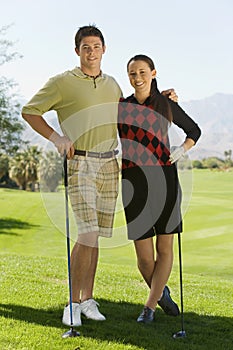 Happy Young Couple On Golf Course