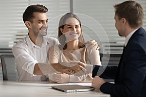 Happy young couple handshake lawyer insurer broker make business deal