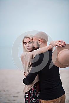 Happy young couple have fun on the beach, holding hands.