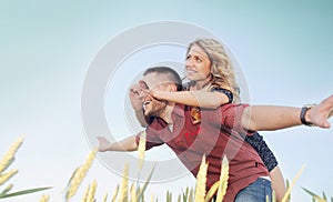 Happy young couple have fun at the field in summer, happy future