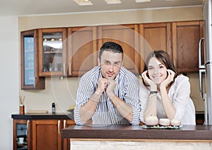 Happy young couple have fun in modern kitchen