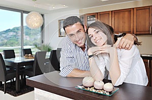 Happy young couple have fun in modern kitchen