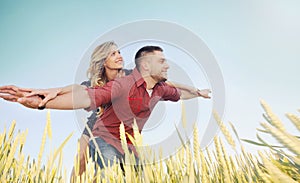 happy young couple have fun at wheat field in summer, happy future concept
