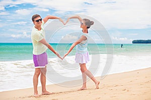 happy young couple having fun by the beach