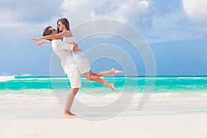 happy young couple having fun by the beach