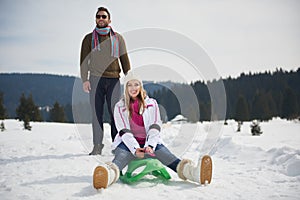 Happy young couple having fun on fresh show on winter vacation