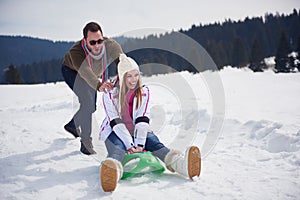 Happy young couple having fun on fresh show on winter vacation