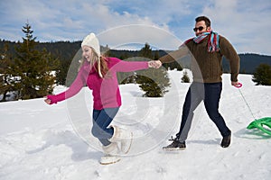 Happy young couple having fun on fresh show on winter vacation