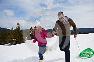 Happy young couple having fun on fresh show on winter vacation