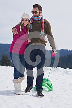 Happy young couple having fun on fresh show on winter vacation