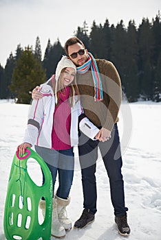 Happy young couple having fun on fresh show on winter vacation