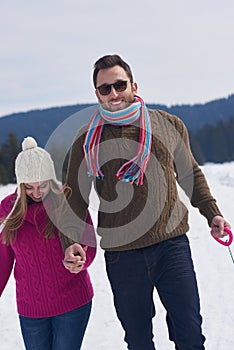 Happy young couple having fun on fresh show on winter vacation